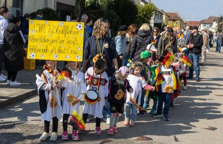 Kinder freuen sich in Trikots auf die Fußball-WM