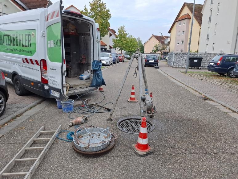 Das Fahrzeug zur Kanalsanierung, daneben Gullydeckel abgedeckt